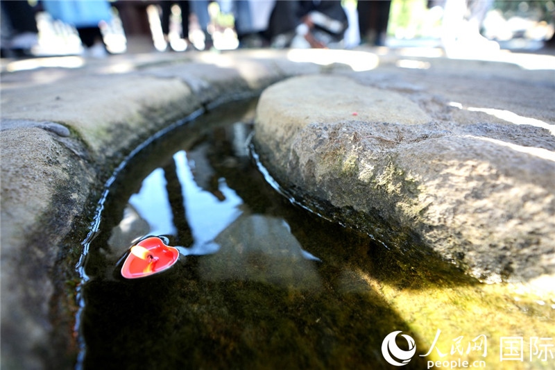 圖為水渠里流過的“桃心”蠟燭。人民網(wǎng) 盧鵬宇攝