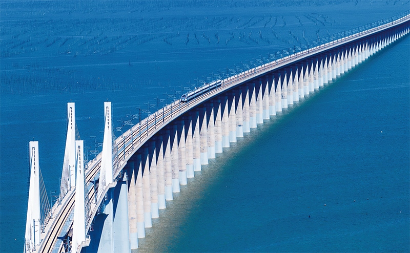 2023年9月28日，中國首條時速350公里跨海高鐵——福廈高鐵正式開通運營。圖為一列運行試驗車組駛過福廈高鐵湄洲灣跨海大橋（9月19日攝，無人機照片）。 新華社記者 魏培全/攝