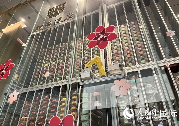 6. 機(jī)械臂正在取貨。（人民網(wǎng)記者陳思 攝）