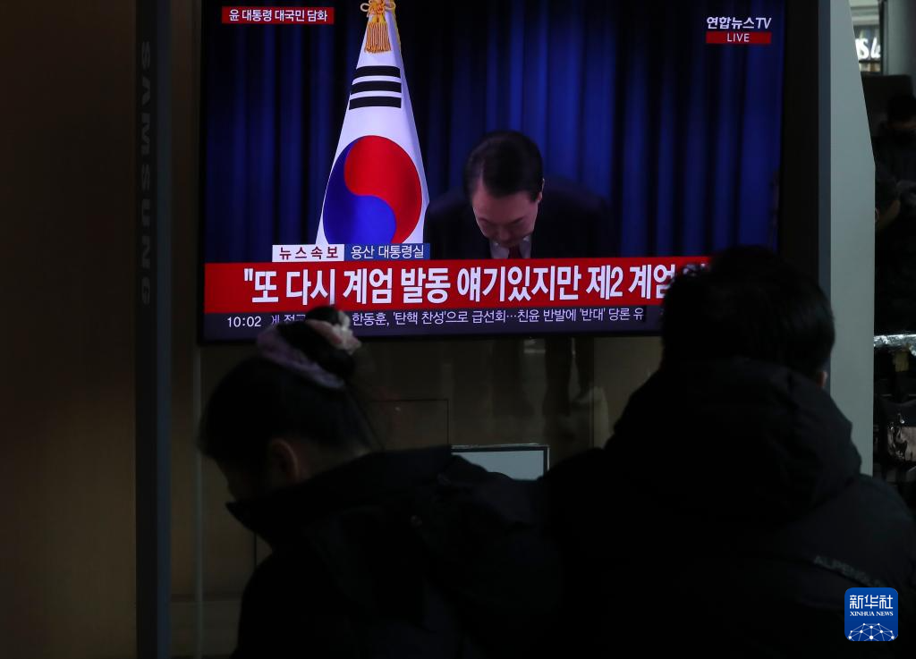 12月7日，在韓國首爾火車站，民眾觀看總統(tǒng)尹錫悅發(fā)表講話的電視畫面。新華社記者 姚琪琳 攝