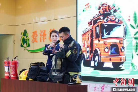 圖為消防員介紹消防裝備。中新社記者 趙宇航 攝